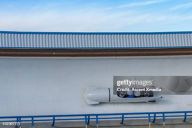 four man bobsled on track, overhead view - bobsleigh stock pictures, royalty-free photos & images