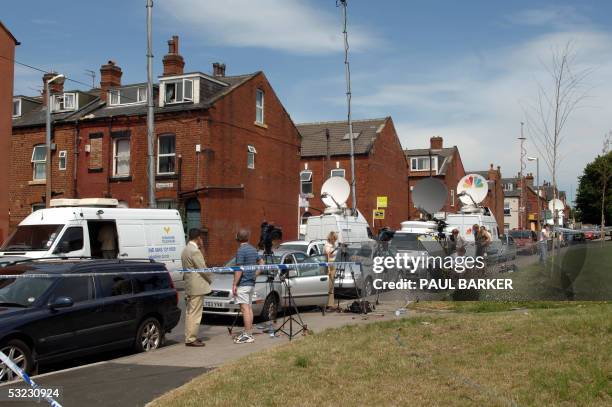 Leeds, UNITED KINGDOM: Journalists stand next to Hyde Park area where a house was raided in connection with last week's London bombings 13 July 2005,...