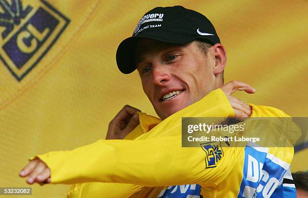 Lance Armstrong of the USA riding for the Discovery Channel cycling team puts on the yellow jersey on the podium after Stage 11 of the 92nd The Tour...