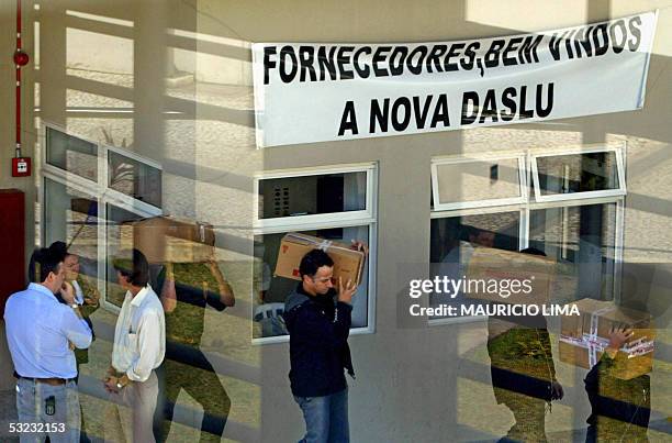 Federal Police agents carry boxes with documents as they leave the Daslu headquarters, one of the most luxurious stores in Brazil, during a raid 13...