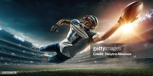 american football player jumping - football ball close up stock pictures, royalty-free photos & images