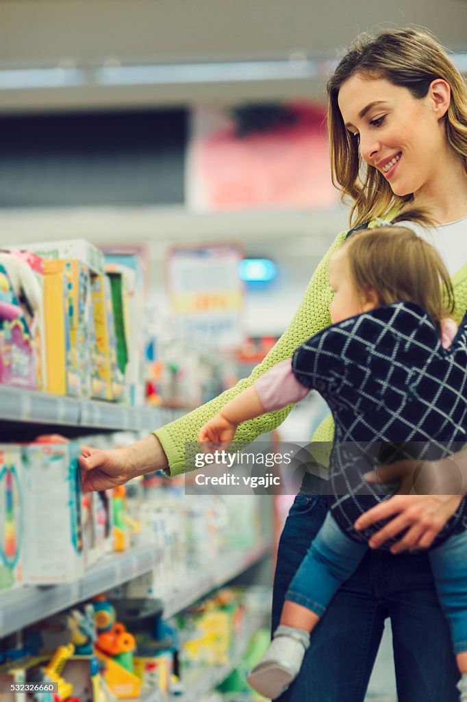 Mother And Her Baby Daughter In Local Supermarket.