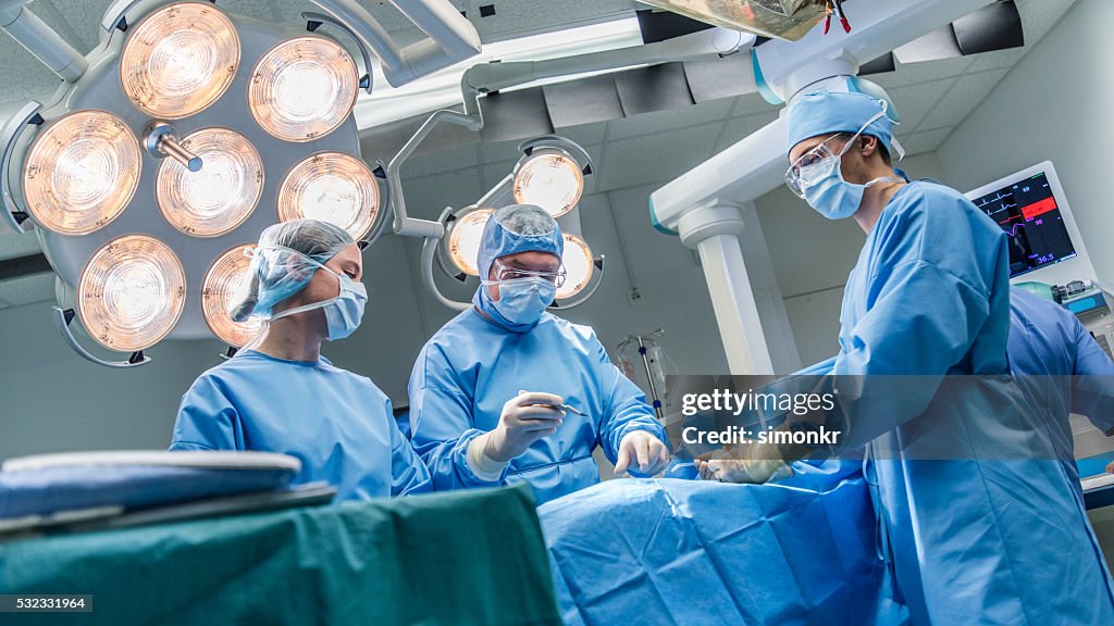 Surgeons in operating theatre