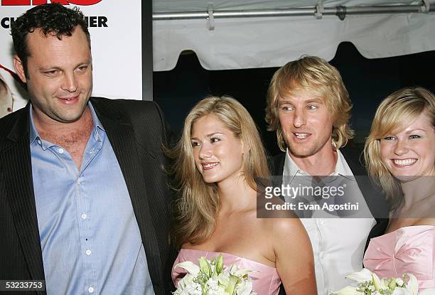 Actors Vince Vaughn and Owen Wilson pose with "bridesmaids" Heidi Bailey and Amelia Nelson at the premiere of "Wedding Crashers" at the Ziegfeld...