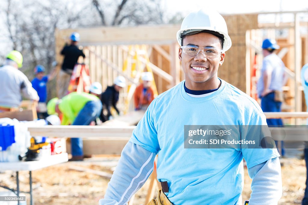 Confident volunteer construction foreman at work site