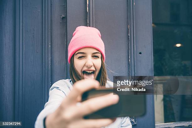 teenager girl make selfie and making grimaces - cute 15 year old girls stock pictures, royalty-free photos & images