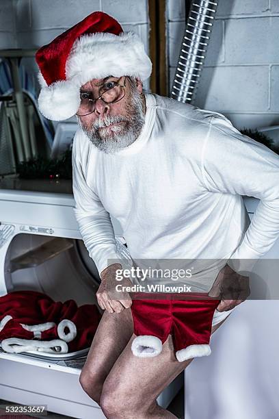 santa claus in deep trouble with shrunken costume pants - too small stock pictures, royalty-free photos & images