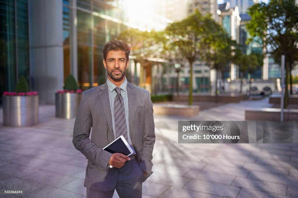 Portrait of a businessman holding a digital tablet