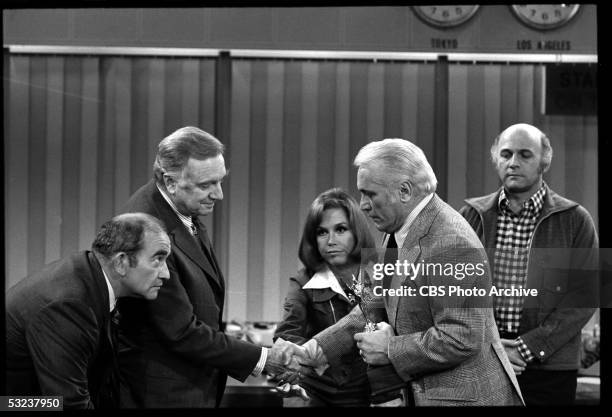 American broadcast journalist Walter Cronkite shakes hands with American actor Ted Knight during the 'Ted Baxter Meets Walter Cronkite' episode of...