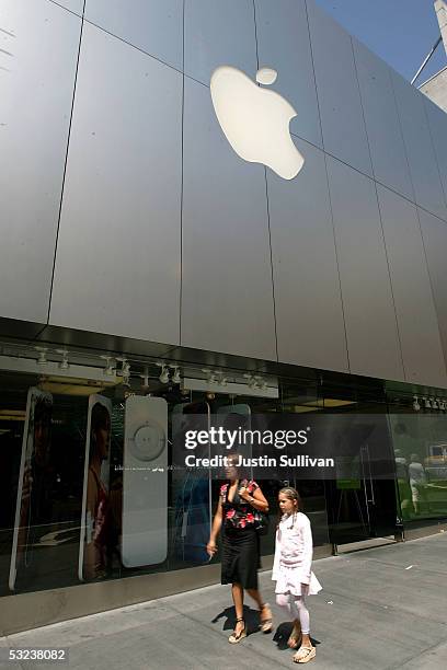 Pedestrians pass the front of the Apple Store July 14, 2005 in San Francisco, California. Shares of Apple Computer surged Thursday after the company...