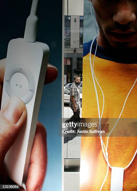 Man looks at a window display for the iPod Shuffle at the Apple Store July 14, 2005 in San Francisco, California. Shares of Apple Computer surged...