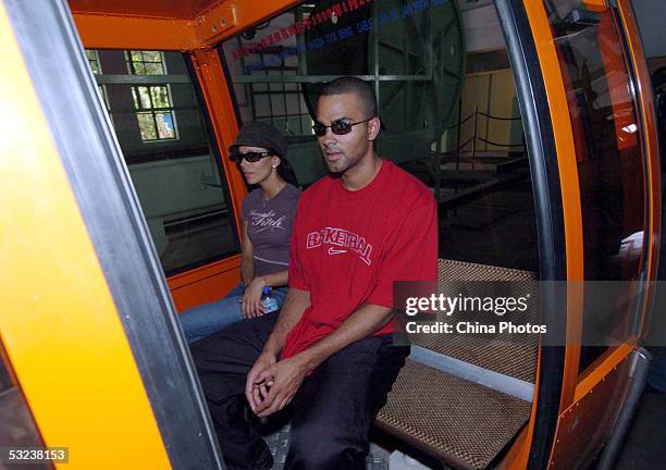 Basketball player Tony Parker of the San Antonio Spurs and his girl friend take a cable car to ascend the Great Wall on July 14, 2005 in Beijing,...