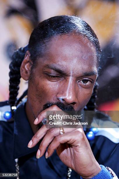 Snoop Dogg smokes a cigar backstage at the Isle Of MTV Club Tour 2005 at Piazza dell'Unita d'Italia on July 14, 2005 in Trieste, Italy. The music...