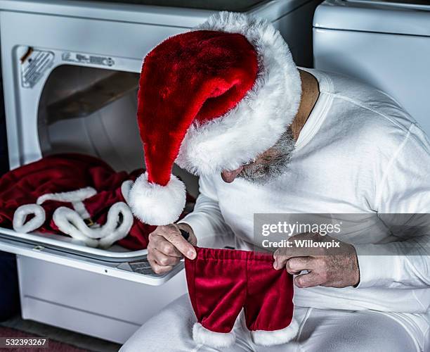 santa claus disbelief with shrunken costume pants - man in tight pants stock pictures, royalty-free photos & images