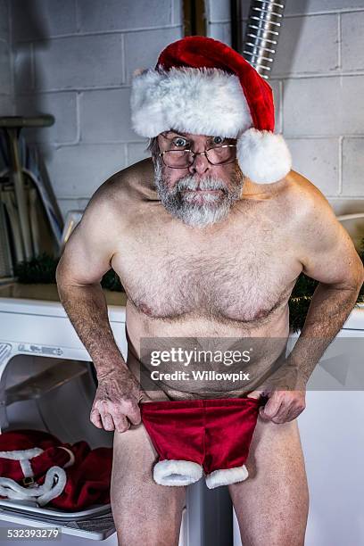 santa claus is naked and shocked with shrunken costume pants - funny mistake stock pictures, royalty-free photos & images