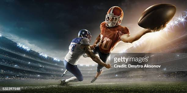 american football player being tackled - touchdown quarterback stock pictures, royalty-free photos & images