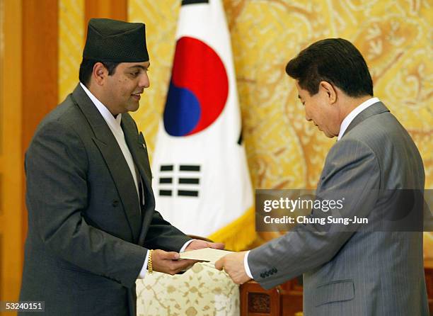 Nepalese Crown Prince Paras Bir Bikram Shah Dev hands an autographed letter from King Gyanendra to South Korean President Roh Moo-Hyun at the...