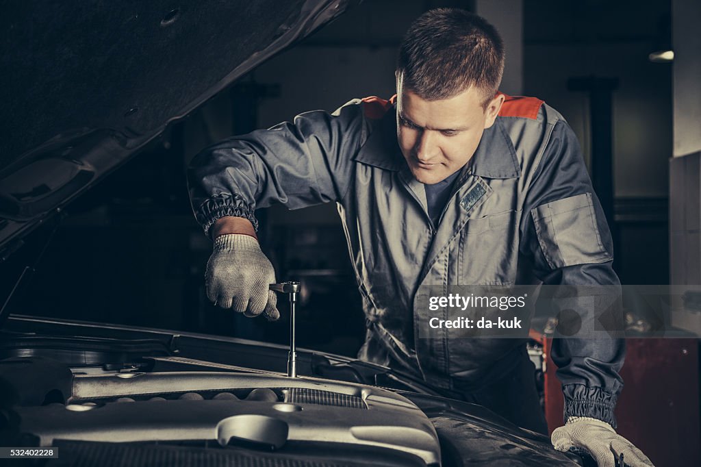 Professional car mechanic working in auto repair service