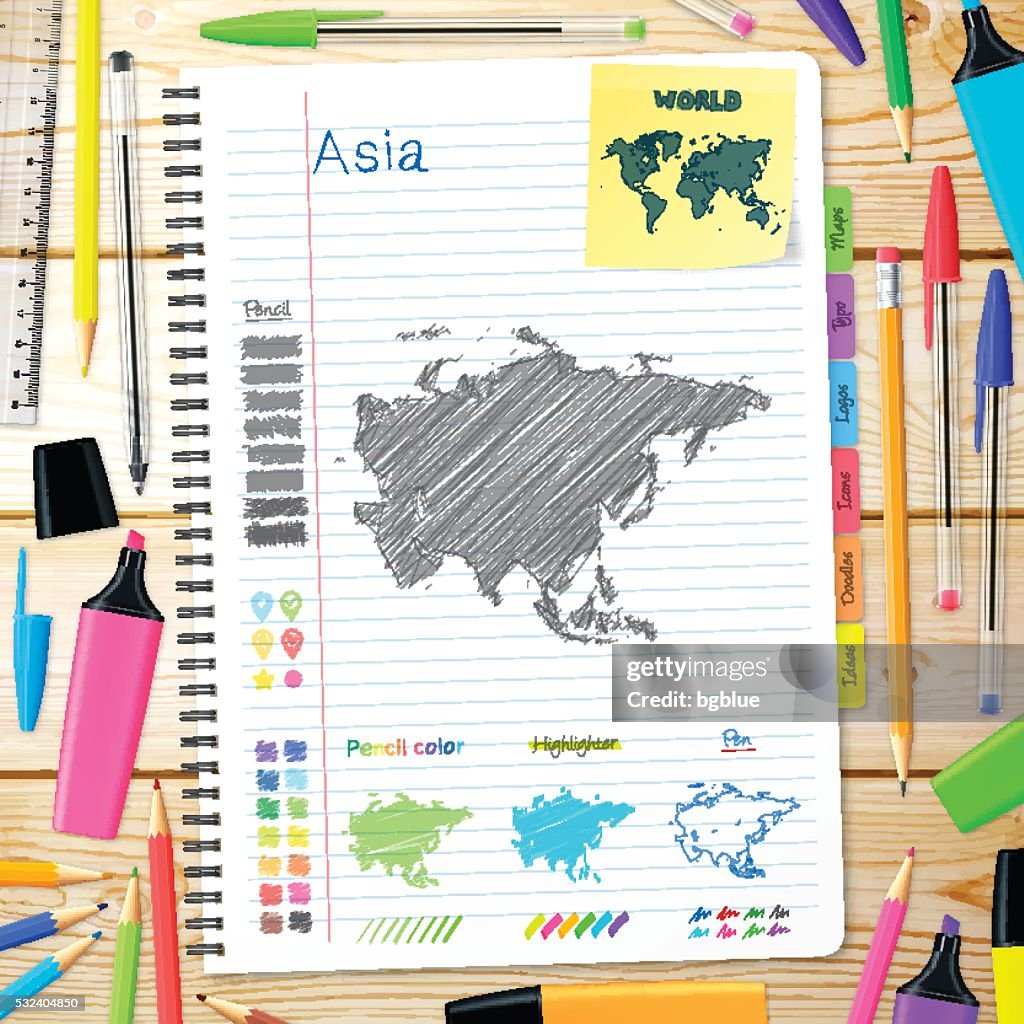 Asia maps hand drawn on notebook. Wooden Background