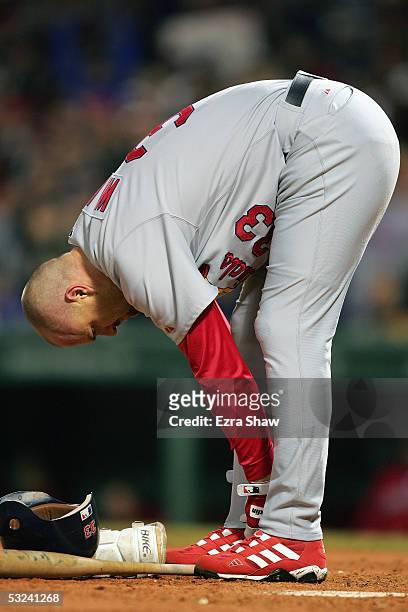 Larry Walker of the St. Louis Cardinals removes his shin guard after striking out against the Boston Red Sox during game two of the 2004 World Series...