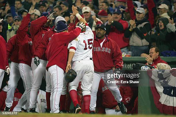 Kevin Millar of the Boston Red Sox celebrates with teammates after scoring a run against the St. Louis Cardinals during game two of the 2004 World...