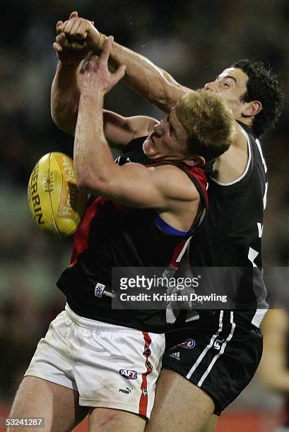 Jason Johnson of the Bombers and Ryan Lonie of the Magpies in action during the round sixteen AFL match between the Collingwood Magpies and Essendon...