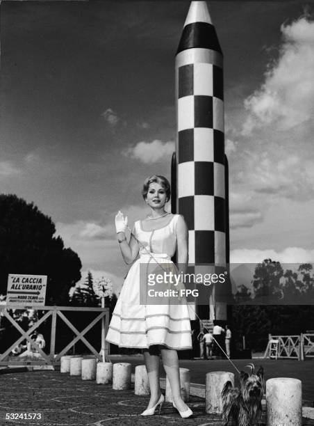 Hungarian actress Zsa Zsa Gabor poses with a yorkshire terrier near a rocket at the Rome Universal Exhibition , Rome, Italy, July 2, 1959. Gabor is...