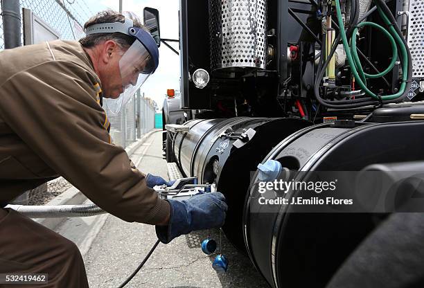 Driver fills up a UPS truck with liquid natural gas, at the Ontario, CA UPS West Coast Hub. Thousands of Trucks through out the country are using...