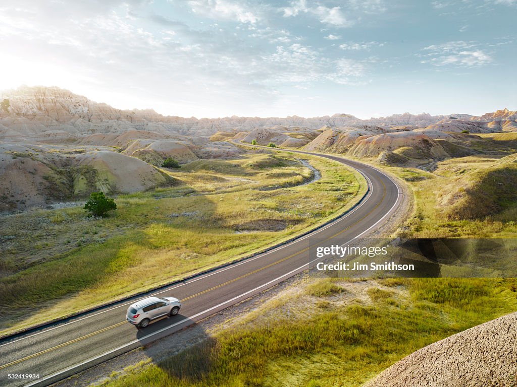 SUV driving through the dramatic landscape of Bandlands National Park