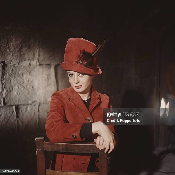 English actress Sarah Miles posed wearing a red suede jacket with matching red hat in 1963.