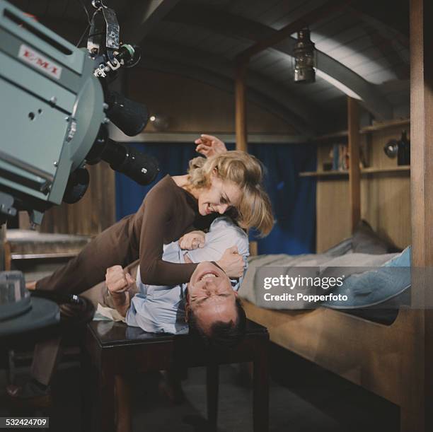 English actress Honor Blackman pictured in character as Cathy Gale fights with a man in a scene from the television drama series The Avengers in 1962.