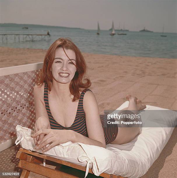 English former model, showgirl and key figure in the Profumo scandal, Christine Keeler posed wearing a swimsuit on a sun lounger on a beach in...