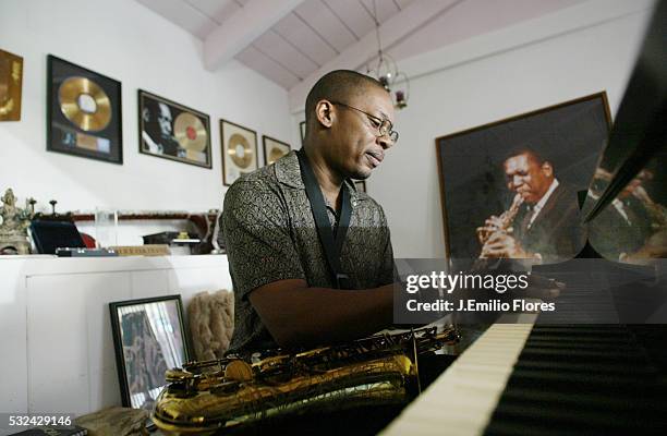 Ravi Coltrane in front of a photograph of his father John Coltrane at his mother Alice's home.