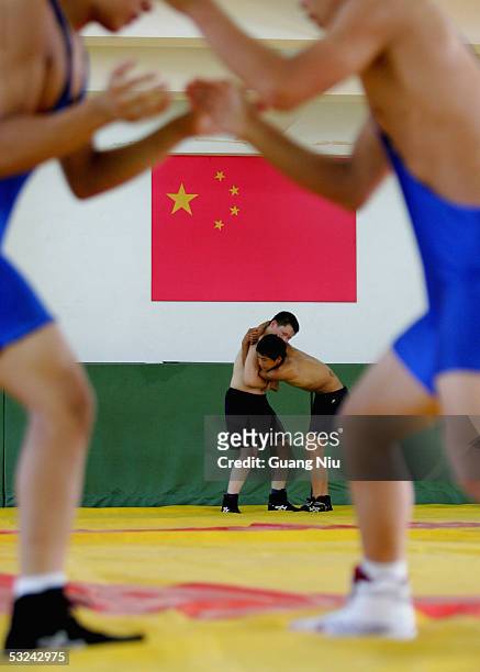 Zhang Yingsong , 16 years-old, and Yang Zhengrong , 13 years-old, train during a wrestling course of Sports School of Dongcheng District on July 14,...