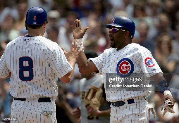 Neifi Perez of the Chicago Cubs celebrates with teammate Michael Barrett after both scored runs against the Pittsburgh Pirates on July 15, 2005 at...