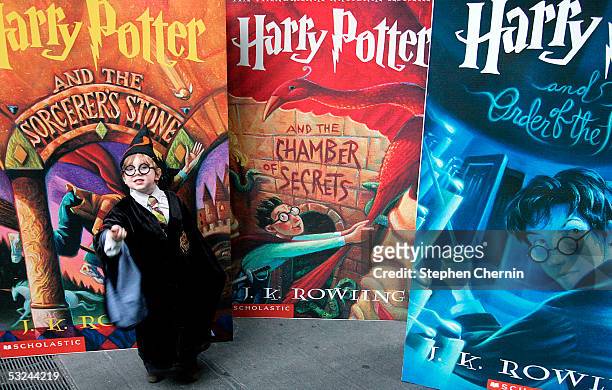 Noah Wohlson, age 4, poses in front of huge displays of other books in the Harry Potter series during a Harry Potter block party July 15, 2005 in New...