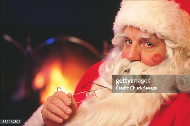 santa claus with lipstick kisses - naughty santa stock pictures, royalty-free photos & images