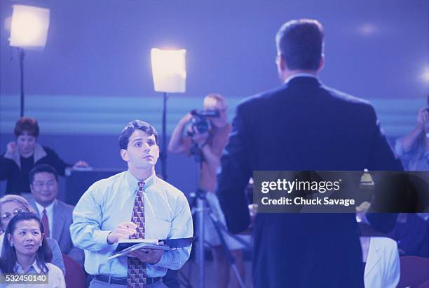 business executive at press conference - press conference reporters stock pictures, royalty-free photos & images