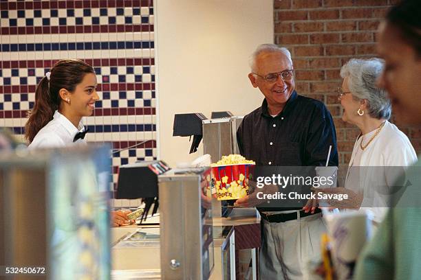 elderly couple buying snacks at movie theater - archival video stock pictures, royalty-free photos & images