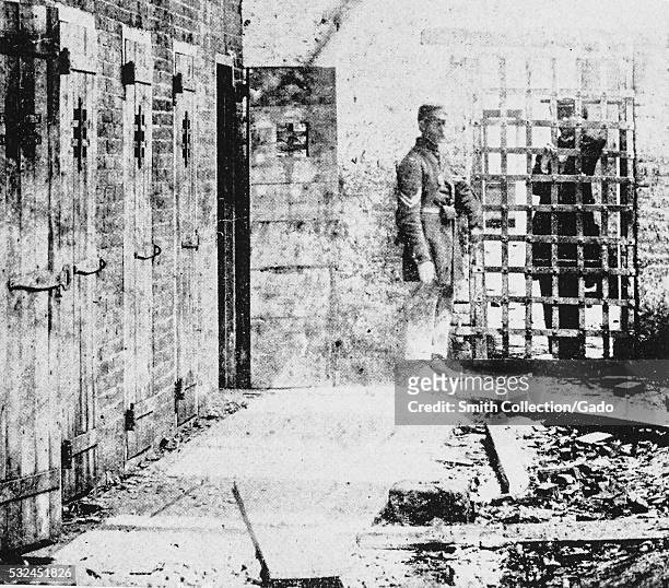 Photograph of the exterior of a slave pen, the pens themselves consist of narrow wooden doors with small holes to allow light in to the cramped...