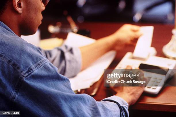 businessman working with adding machine - adding machine tape stock pictures, royalty-free photos & images
