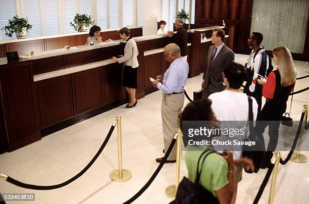 bank customers in line - banking stock pictures, royalty-free photos & images