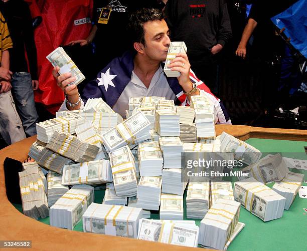 Australian Joseph Hachem kisses some of the $7.5 million he won on the final day of competition at the World Series of Poker no-limit Texas Hold 'em...