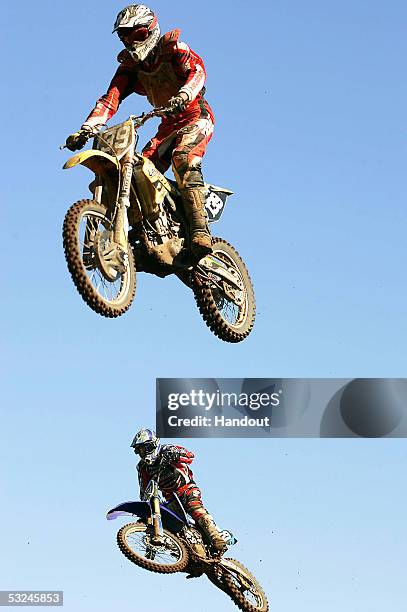 In this handout image provided by Tostee.com, South African wildcard rider JP De Beer and Anthony Boissiere of France jump during MX2 qualifying of...