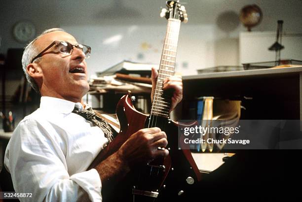 businessman playing electric guitar - amateur stock pictures, royalty-free photos & images