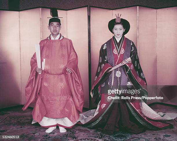 Crown Prince Akihito and Crown Princess Michiko of Japan pictured together wearing their traditional wedding attire of a sokutai for him and a...