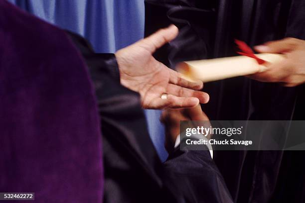 a hand shake and a diploma - perfect moment stock-fotos und bilder