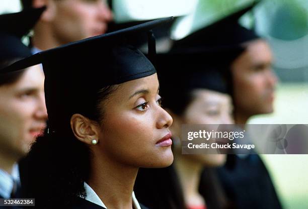 graduates during commencement ceremony - black woman graduation stock pictures, royalty-free photos & images