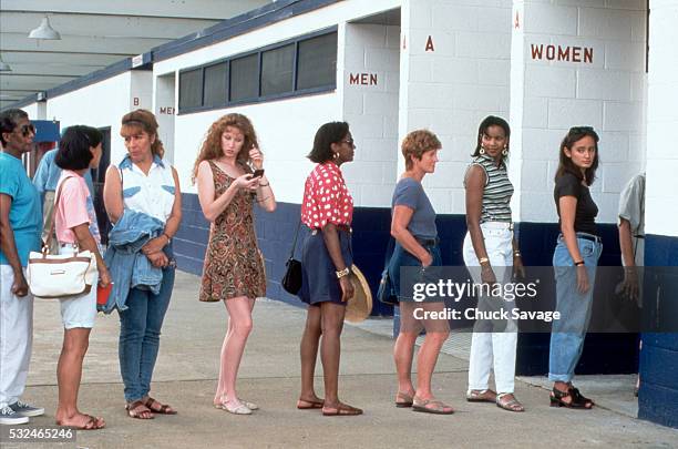 women in line for the restroom - queuing stock-fotos und bilder