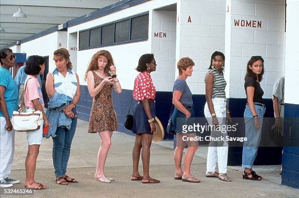 women in line for the restroom - queue photos et images de collection